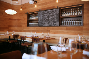 Boqueria’s Dupont Circle tapas bar set for a private event with the nights dishes on a chalkboard surrounded by sparkling water bottles.